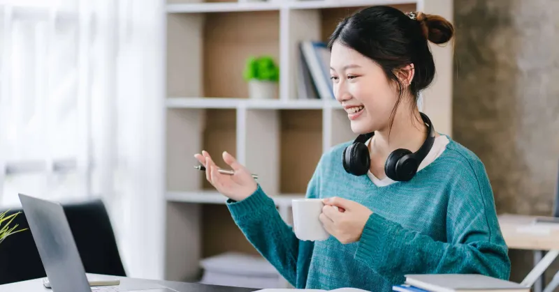 Smart and positive Asian female freelancer or student studying o